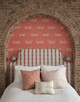 Chicago Lemon fabric patterned upholstered headboard with leopard-print wallpaper backdrop. Interior by Studio DB. Photography by Matthew Williams.
